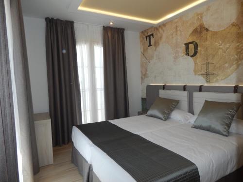 a bedroom with a large bed in front of a window at Hostal Boutique Doña Carmen - Adults Recommended in Nerja
