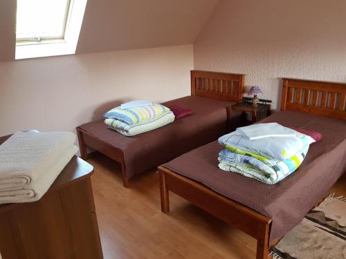 two beds with pillows on them in a room at Zvaigžņu māja in Pāvilosta