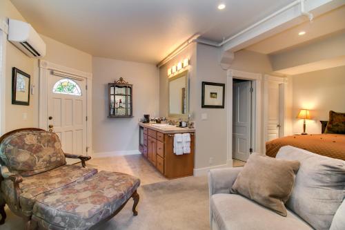a bedroom with a bed and a bathroom with a sink at Winchester Inn in Ashland