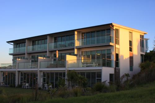 an apartment building with a lot of windows at Doubtless Bay Villas in Cable Bay