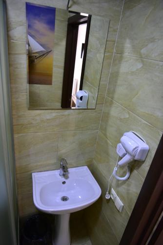 a bathroom with a sink and a mirror at The K Tbilisi in Tbilisi City
