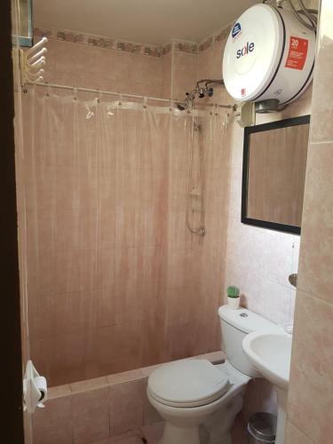a bathroom with a shower and a toilet and a sink at Hospedaje de Lidia in Lima