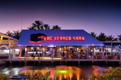 a restaurant with a neon sign on the front of it at Ibis Bay Resort in Key West
