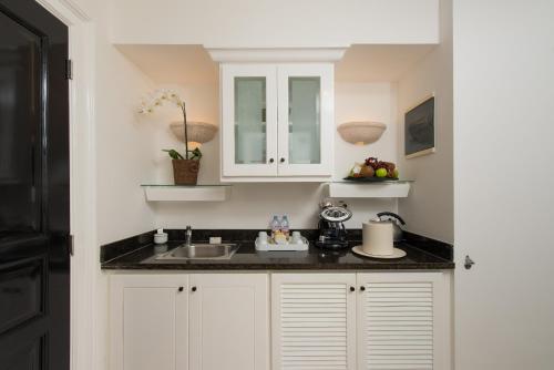 a kitchen with white cabinets and a sink at Tortuga Bay in Punta Cana
