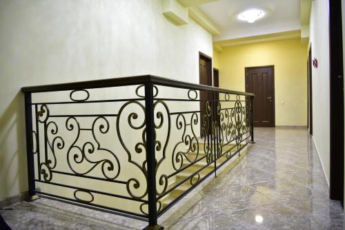 a hallway with a black wrought iron railing at The K Tbilisi in Tbilisi City