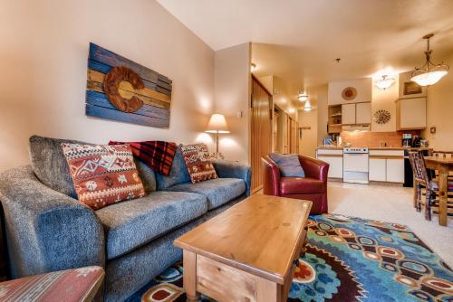 a living room with a couch and a table at Snow Flower Condos in Steamboat Springs