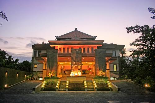a large building with lights in front of it at Pelangi Bali Hotel & Spa in Seminyak