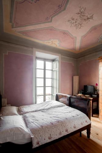 a bedroom with a bed with a coffered ceiling at Bellavista Boutique Hotel in Brunate