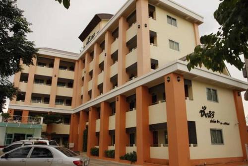 a large building with a car parked in front of it at Chaisiri Park View in Ban Nong Lup