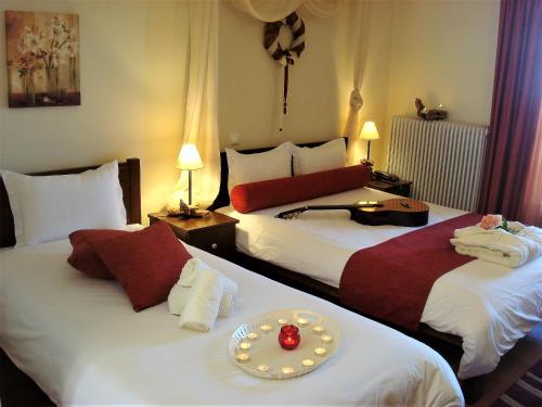 a hotel room with two beds with a plate on it at Guesthouse Amanitis Caesarea in Skíti