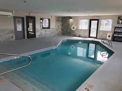 a large swimming pool in a building with blue water at Baymont by Wyndham Moses Lake in Moses Lake