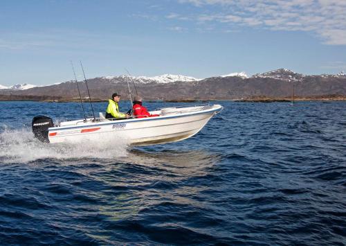two people on a boat in the water at Offersøy Feriesenter in Offersøy