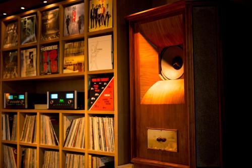 a room with a book shelf filled with records at Kaname Inn Tatemachi in Kanazawa