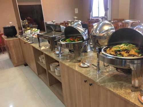 a buffet line with plates of food on it at Jade Garden Hote in Gukeng
