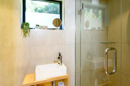 a bathroom with a sink and a shower at EcoScapes in Glenorchy