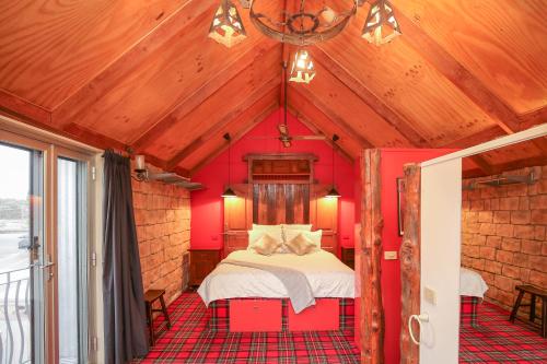a bedroom with a bed in a red room at The Stable On Olive in Mildura