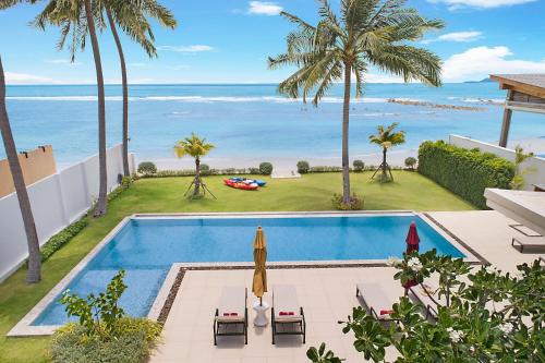 a swimming pool with a view of the ocean at Villa SeaNest Samui in Laem Sor
