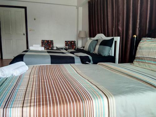 Ένα ή περισσότερα κρεβάτια σε δωμάτιο στο Lomsabai Apartments