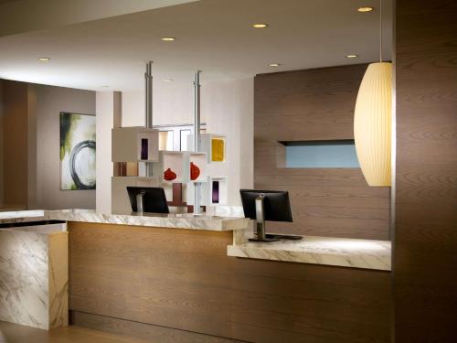 a lobby with a reception desk with two chairs at Hyatt House Atlanta Downtown in Atlanta