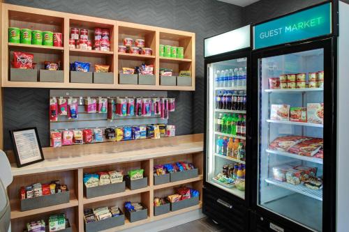 a store with a refrigerator filled with lots of food at Hyatt House Dallas Lincoln Park in Dallas