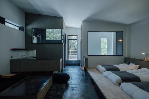 a bedroom with two beds and a large window at yl & Co. Hotel in Mt.Fuji in Fujikawaguchiko