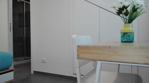 a vase of flowers on a table in a room at Tivoli ShortLets - Catania in San Gregorio di Catania