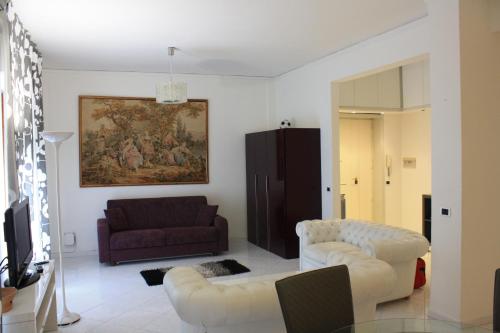 a living room with a couch and two chairs at Sorrento Nest Rose in Sorrento
