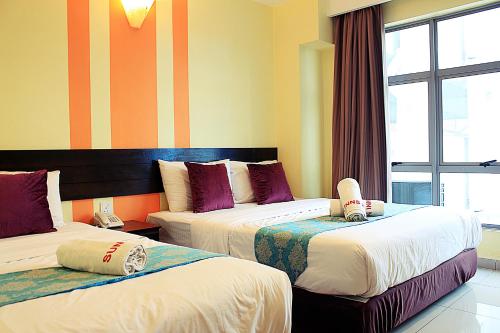 Ένα ή περισσότερα κρεβάτια σε δωμάτιο στο Sun Inns Hotel KopKastam Kelana Jaya