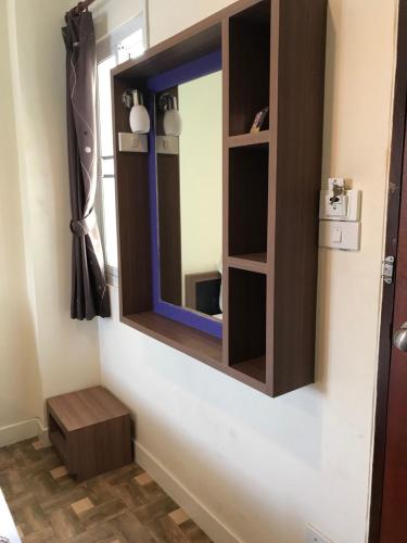 a mirror on the wall of a bathroom at Samsen Sam Place in Bangkok
