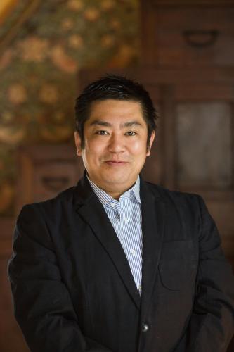 a man in a suit and tie posing for a picture at Bamba Hotel Tokyo-Private Townhouse- in Tokyo