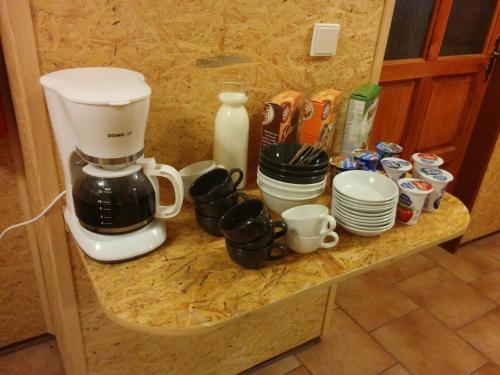 a counter with a coffee maker and cups on it at Pension Fontána Svitavy in Svitavy