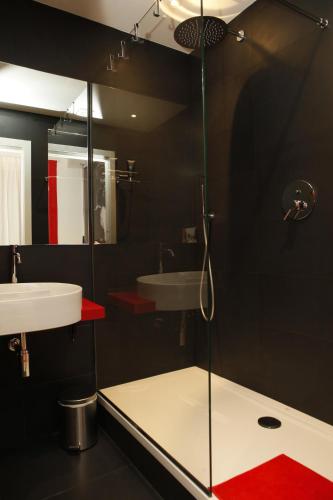 a bathroom with a glass shower and a sink at TRNAPT Torino Apartments PORTA SUSA in Turin