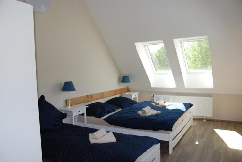 En eller flere senge i et værelse på Apartment Ptačí Dům