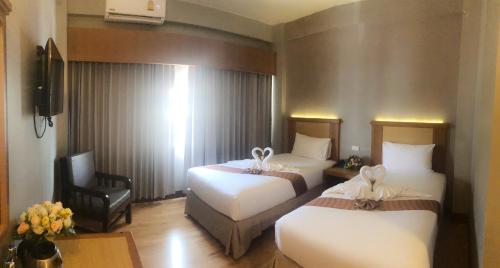 Ένα ή περισσότερα κρεβάτια σε δωμάτιο στο D-ONE Hotel