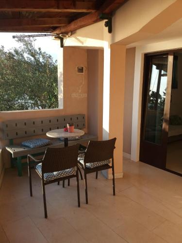 a patio with chairs and a table and a table and a window at Apartment Feral in Neum