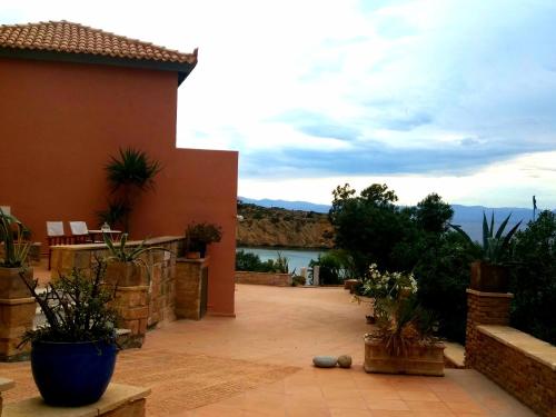 a view of a house with a view of the water at Vrachokipos in Souvala
