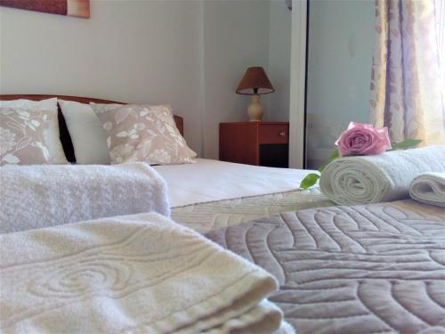 a bedroom with two beds with towels on them at Irini seaside studios in Nikiana
