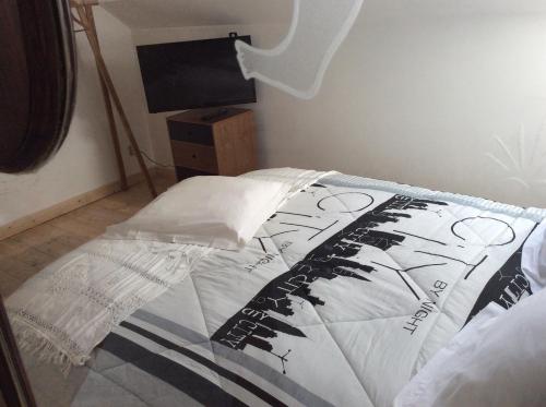 a bedroom with a bed and a television in it at Gîtes du Grand Bois in Maubeuge