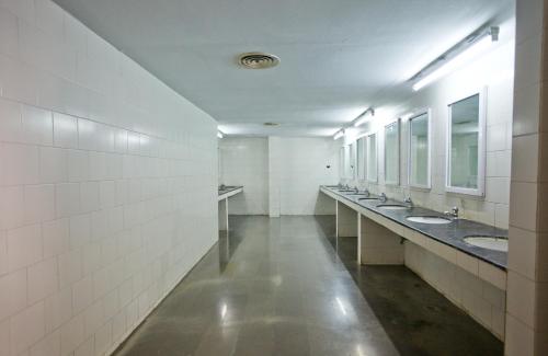 a bathroom with a row of sinks and mirrors at Ramoji Sahara Shared Accommodation in Pedda Ambarpet