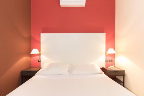 Un ou plusieurs lits dans un hébergement de l'établissement Hotel La Baia