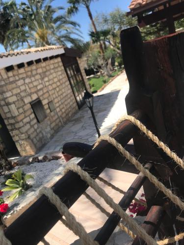 a wooden bench sitting next to a building at De Michanna in Anarita