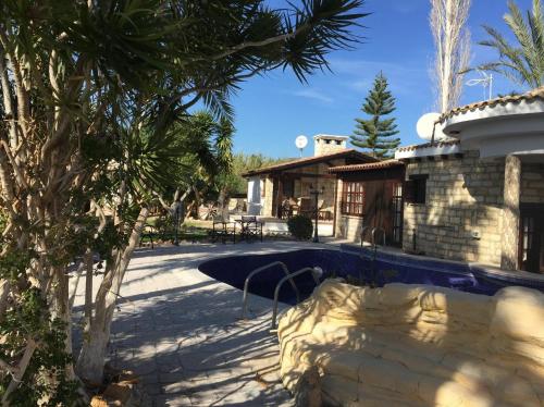 a villa with a swimming pool and a house at De Michanna in Anarita