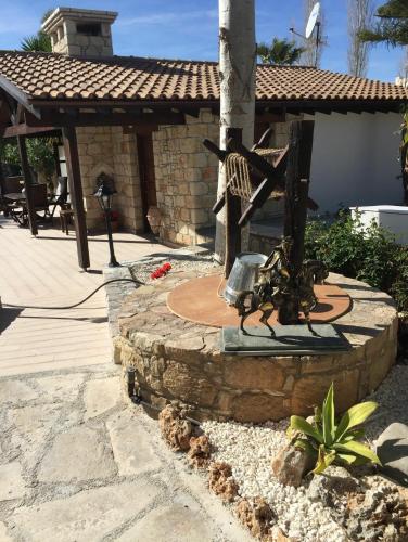 a stone patio with a fountain in front of a building at De Michanna in Anarita