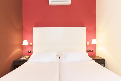 Un ou plusieurs lits dans un hébergement de l'établissement Hotel La Baia