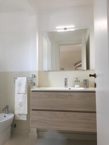 a bathroom with a sink and a mirror at Basiliscus in Sternatia