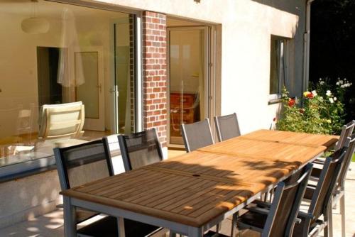 einen Holztisch und Stühle auf einer Terrasse in der Unterkunft Apartment Sternentor in Engerwitzdorf
