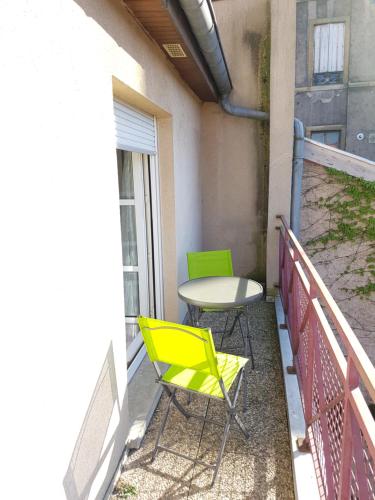 a patio with two chairs and a table on a balcony at Metz Port Saint Marcel in Metz