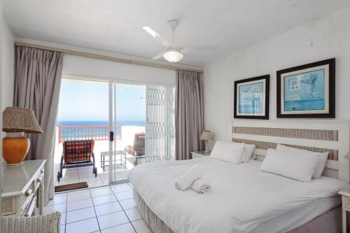 a bedroom with a bed and a view of the ocean at Skiathos 8 - FAMILY ONLY - Max 6 adults and 2 children in Ballito