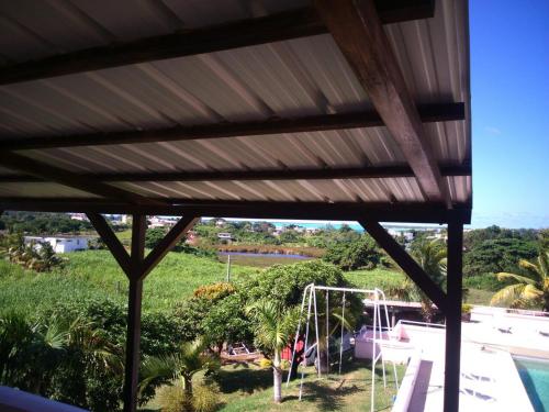 a view from the patio of a house with a roof at Villa Victoria in Trou dʼ Eau Douce