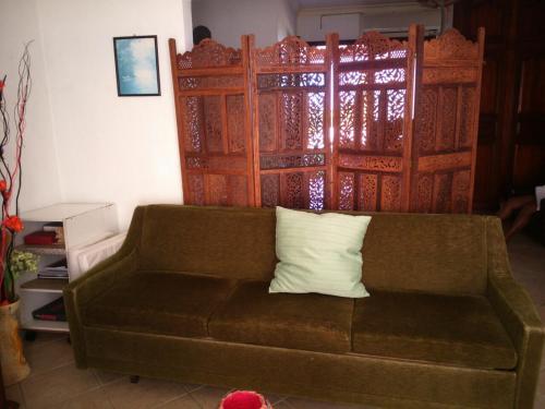 a couch with a pillow on it in a living room at Villa Victoria in Trou dʼ Eau Douce